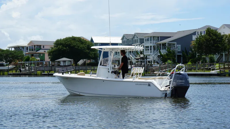 Slide: The Image of 2016 Sea Hunt Ultra 225 boat on water near waterfront homes. - 5