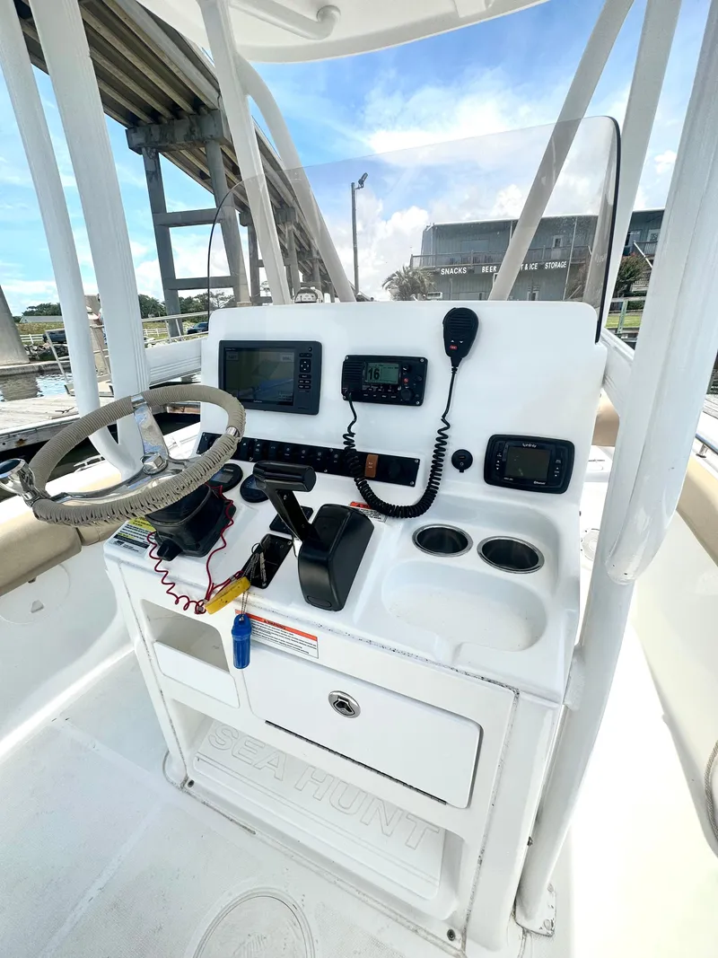Slide: The Image of 2016 Sea Hunt Ultra 225 boat console with steering wheel, electronics, and controls. - 6