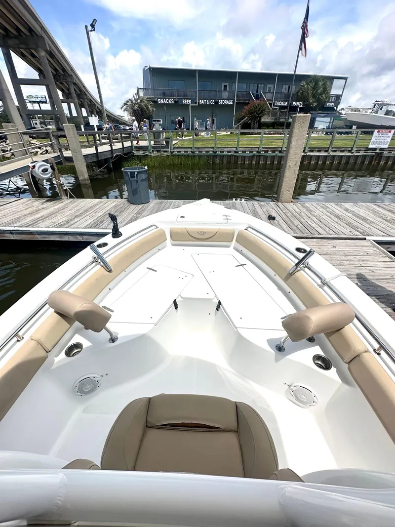 Slide: The Image of 2016 Sea Hunt Ultra 225 boat docked, featuring spacious seating and modern design. - 7