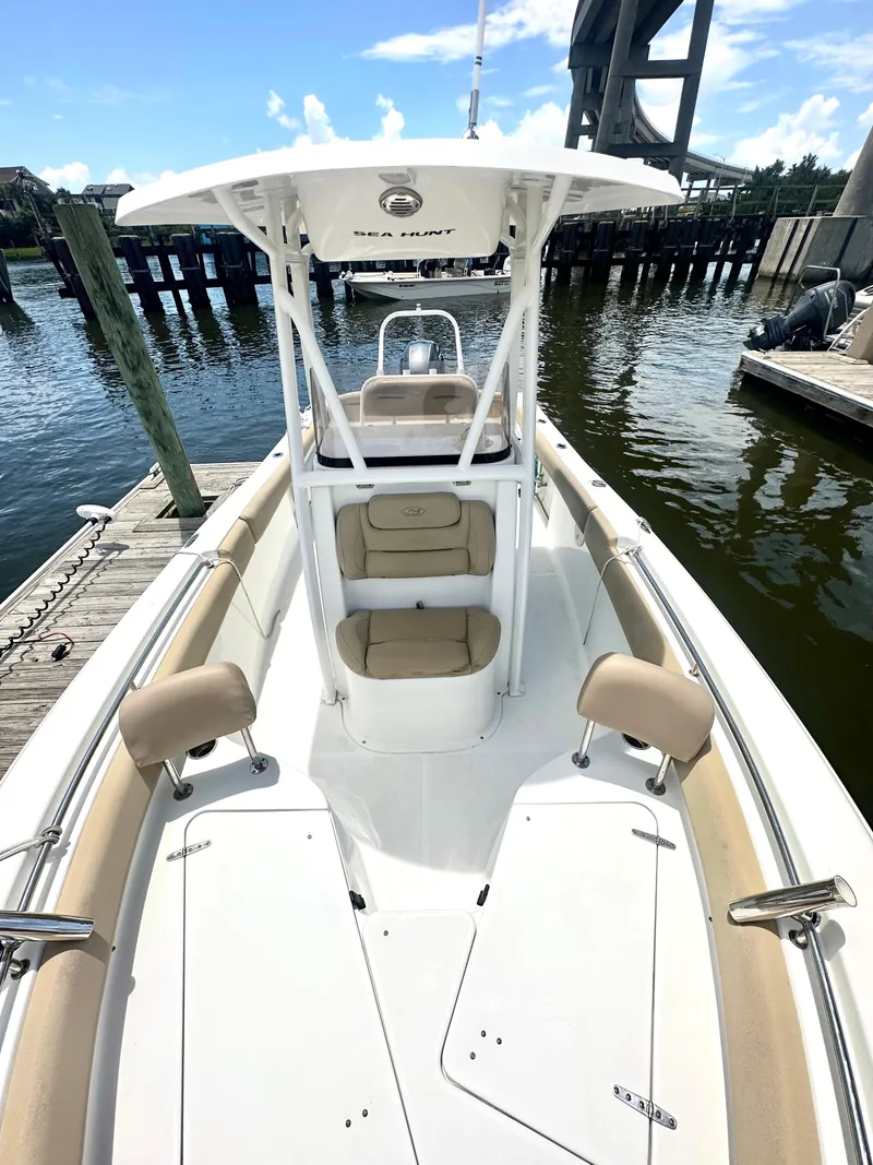 Slide: The Image of 2016 Sea Hunt Ultra 225 boat docked, featuring spacious seating and sleek design. - 8