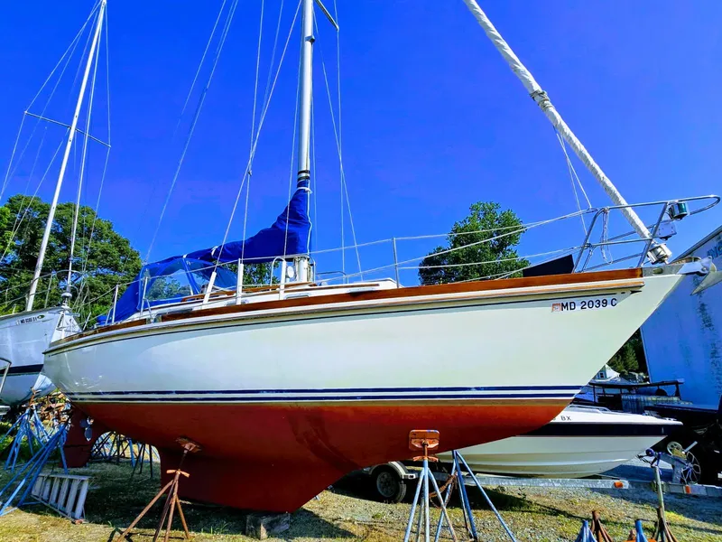 Slide: The Image of 1984 Bristol 31.1 Keel Centerboard sailboat on stands, clear blue sky background. - 0
