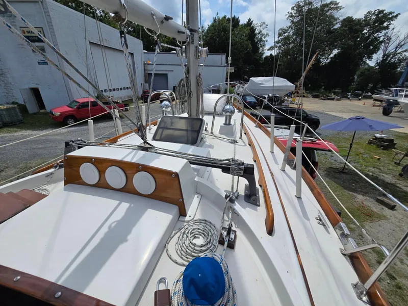Slide: The Image of 1984 Bristol 31.1 sailboat deck with ropes and equipment in a boatyard setting. - 12
