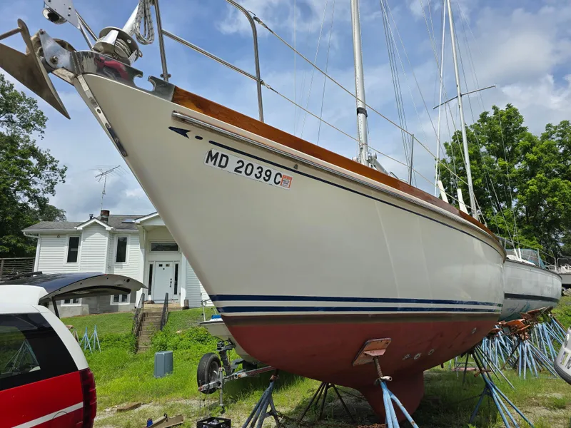 Slide: The Image of 1984 Bristol 31.1 sailboat on stands, with registration MD 2039C, near a white house. - 16