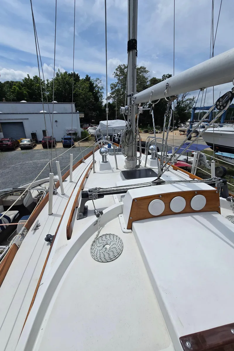 Slide: The Image of 1984 Bristol 31.1 sailboat deck with mast, rigging, and clear sky background. - 20