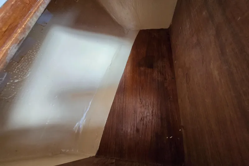 Slide: The Image of Interior view of a 1984 Bristol 31.1 boat, showcasing wooden and painted surfaces. - 25