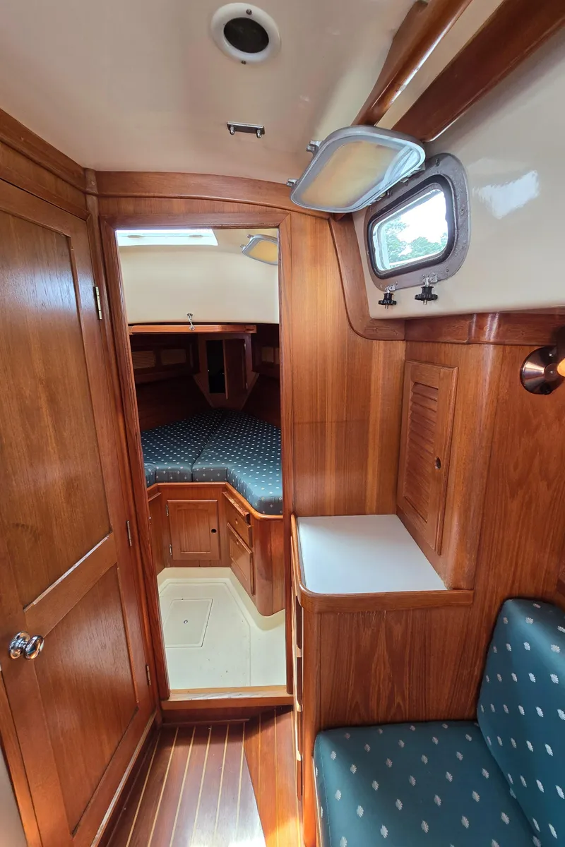 Slide: The Image of Interior of 1984 Bristol 31.1 sailboat with wood paneling and cozy cabin space. - 26