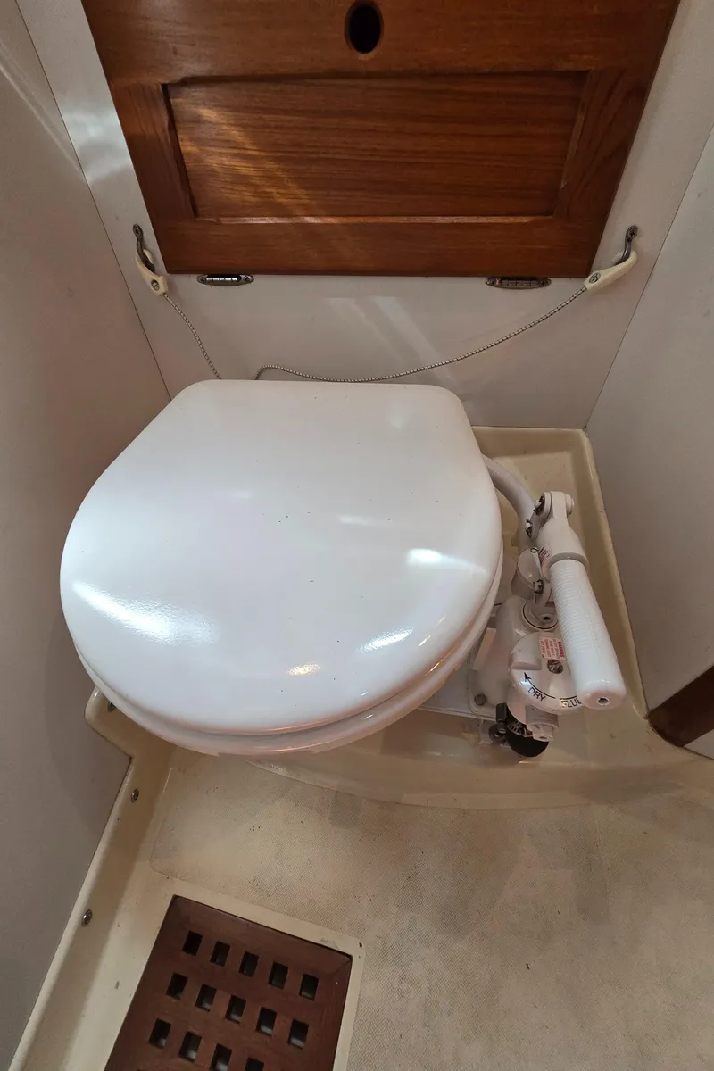Slide: The Image of Marine toilet in 1984 Bristol 31.1 sailboat, featuring a manual pump system. - 29