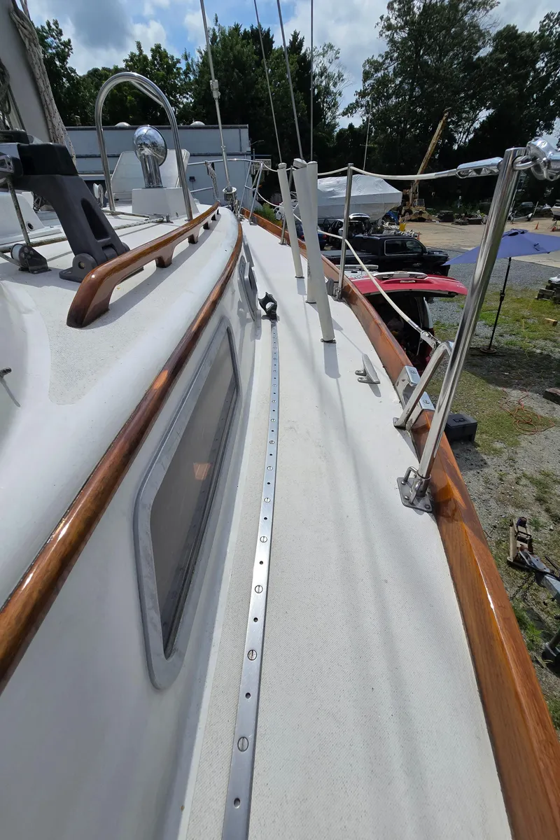 Slide: The Image of 1984 Bristol 31.1 sailboat deck with wooden trim and metal fittings. - 30
