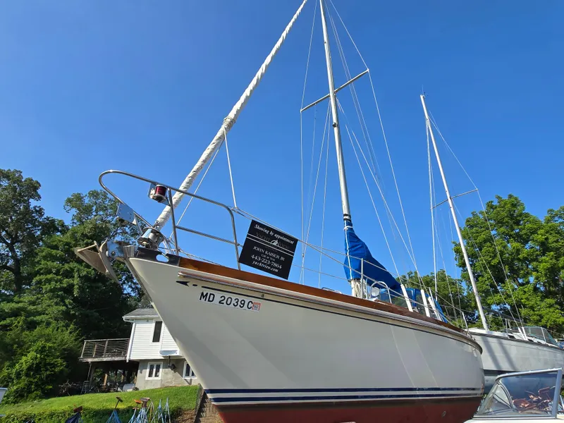 Slide: The Image of 1984 Bristol 31.1 Keel Centerboard sailboat on land, clear blue sky background. - 46