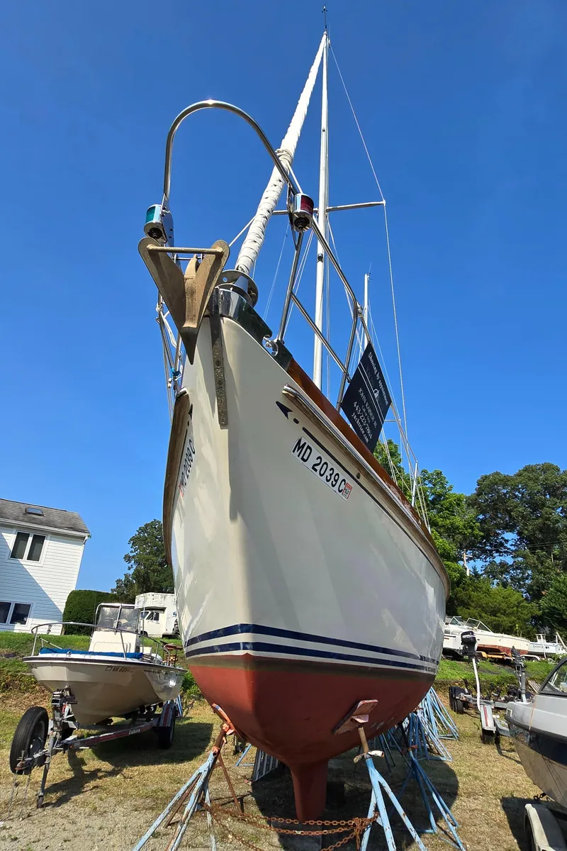 Slide: The Image of 1984 Bristol 31.1 Keel centerboard sailboat on stands, clear blue sky background. - 48