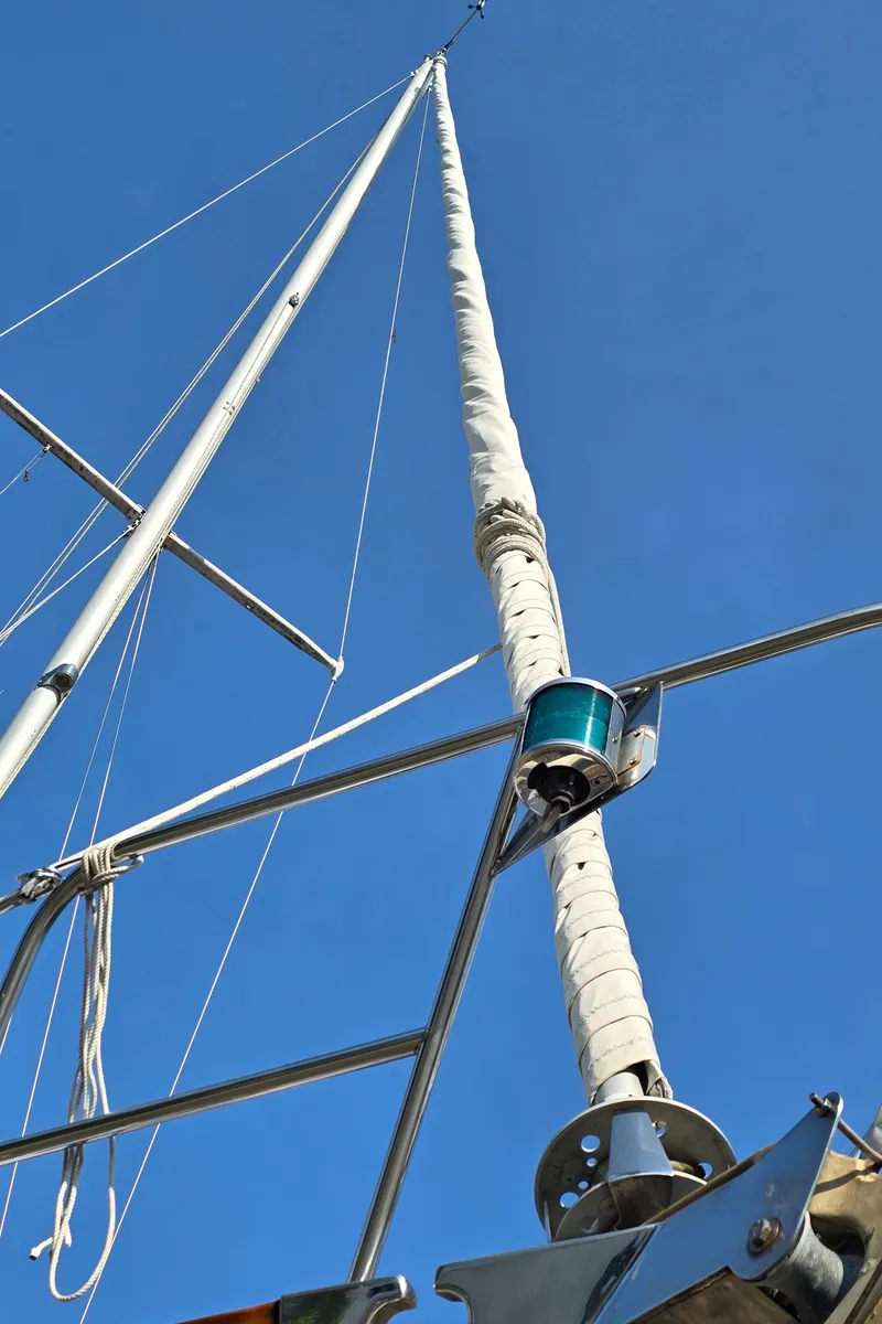 Slide: The Image of Mast and rigging of 1984 Bristol 31.1 Keel centerboard sailboat against clear blue sky. - 49