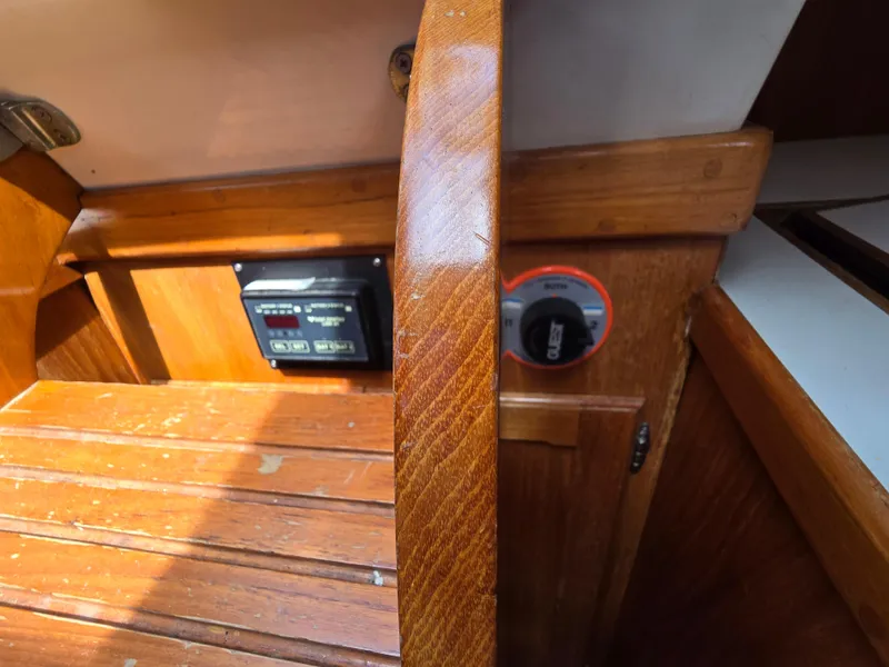 Slide: The Image of Wooden interior of a 1984 Bristol 31.1 boat with control panel and switch. - 7