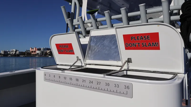 Slide: The Image of Freeman 47 boat, 2021 model, with "Please Don't Slam!" signs on storage compartments. - 13