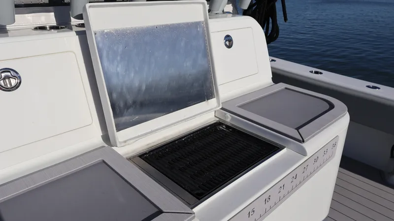 Slide: The Image of Freeman 47 boat grill and prep station, 2021 model, on a sunny day by the water. - 14