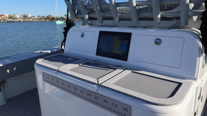 Slide: The Image of Freeman 47 boat console with navigation screen, 2021 model, on calm water. - 23