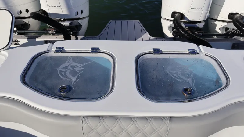 Slide: The Image of Freeman 47 boat livewells with marlin design, 2021 model, featuring dual outboard engines. - 26