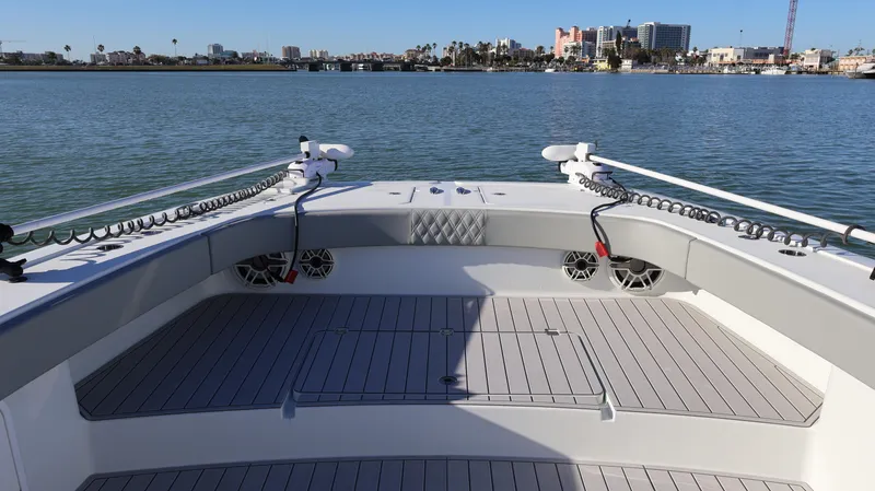 Slide: The Image of Bow view of a 2021 Freeman 47 boat on calm waters with cityscape background. - 39