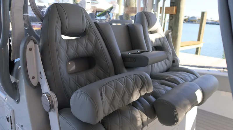 Slide: The Image of Luxurious leather seating on a 2021 Freeman 47 boat, featuring diamond stitching and armrests. - 47