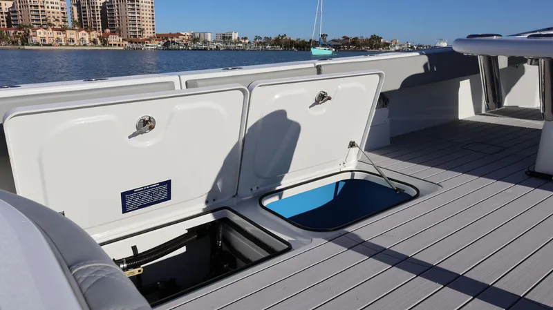 Slide: The Image of 2021 Freeman 47 boat deck with open storage compartments, overlooking a waterfront cityscape. - 51