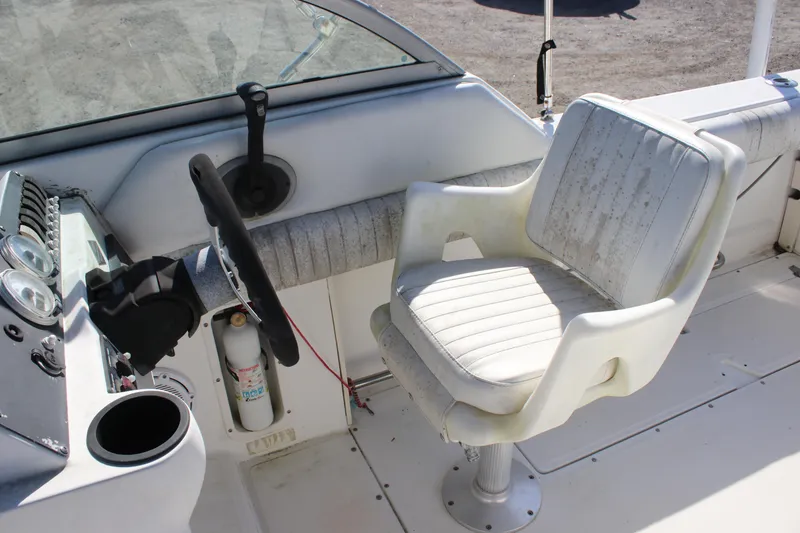 Slide: The Image of 2004 Boston Whaler 210 Ventura boat cockpit with steering wheel and captain's chair. - 9