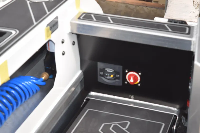 Slide: The Image of Interior view of 2026 Stabicraft 1850 Supercab Sportfish boat with control panel and blue hose. - 17