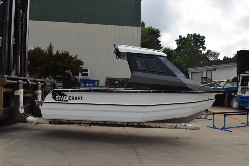 Slide: The Image of 2026 Stabicraft 1850 Supercab Sportfish boat on a lift, outdoor setting. - 3