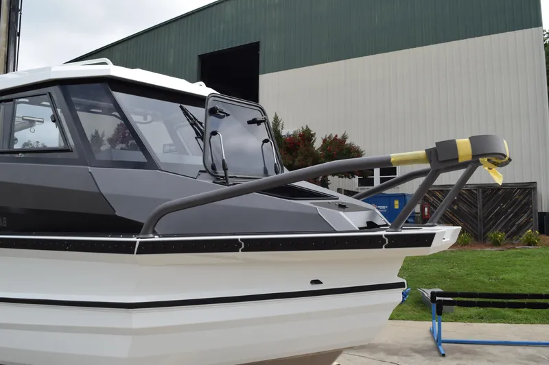 Slide: The Image of 2026 Stabicraft 1850 Supercab Sportfish boat, docked near a large building. - 4