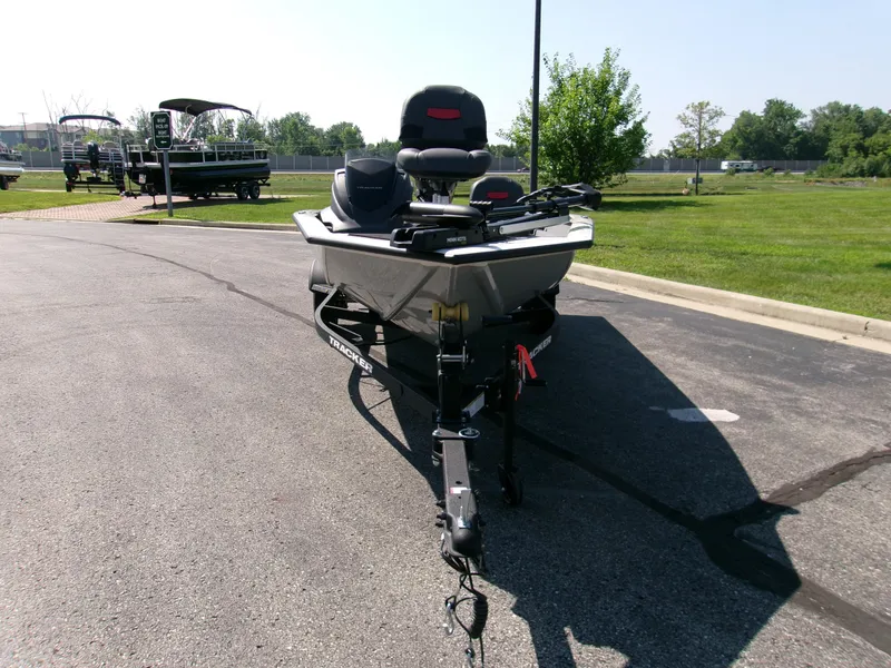 Slide: The Image of 2025 Tracker Pro Team 175 Crappie Edition boat on trailer in parking lot. - 3