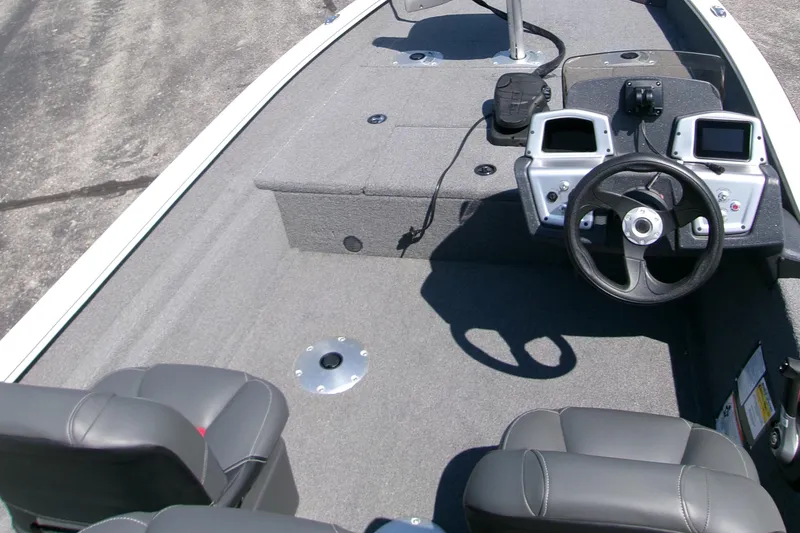 Slide: The Image of 2025 Tracker Pro Team 175 Crappie Edition boat interior with steering wheel and seats. - 5