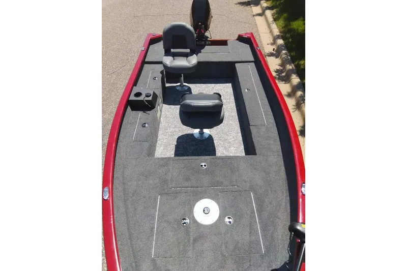 Slide: The Image of 2025 Tracker Super Guide V-16 T fishing boat interior with two seats and carpeted deck. - 2