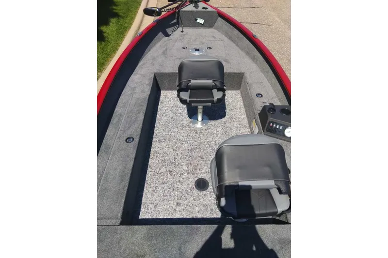 Slide: The Image of 2025 Tracker Super Guide V-16 T boat interior with two seats and control panel. - 4