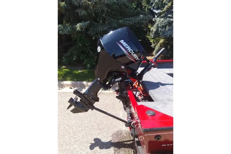 Slide: The Image of 2025 Tracker Super Guide V-16 T with Mercury outboard motor, parked outdoors. - 5