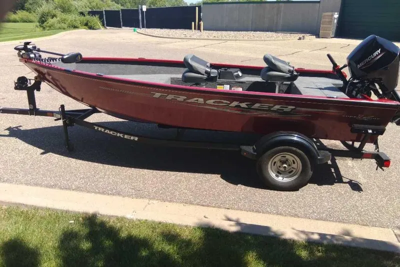 Slide: The Image of 2025 Tracker Super Guide V-16 T fishing boat on trailer, parked outdoors. - 6