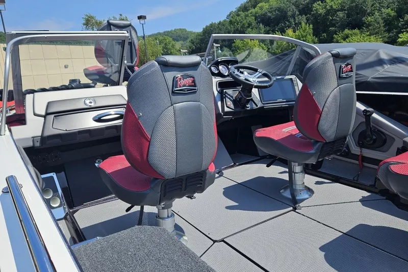 Slide: The Image of 2025 Ranger 620FS Cup Equipped boat interior with red and gray seating, steering console, and dashboard. - 3