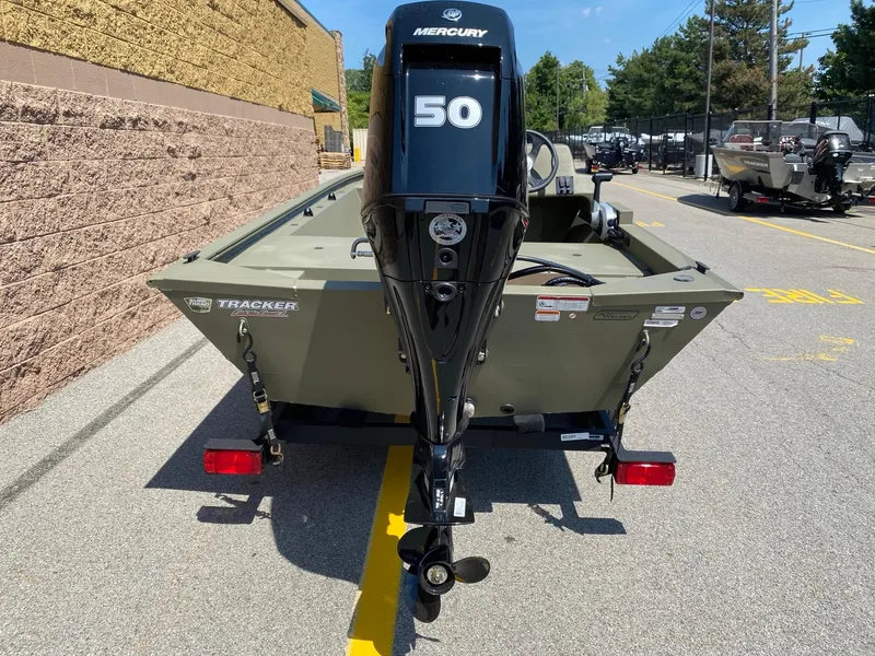 Slide: The Image of 2024 Tracker Grizzly 1648 SC boat with Mercury 50 engine, parked outdoors. - 3