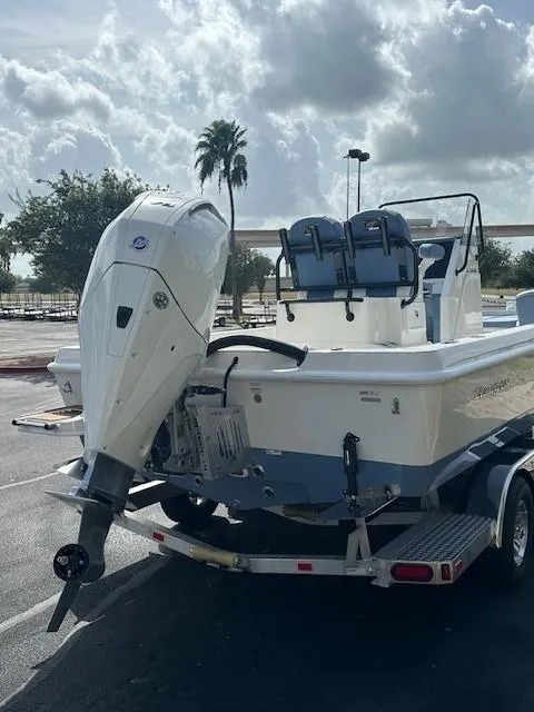Slide: The Image of 2025 Ranger 2360 Bay boat on trailer, parked outdoors under cloudy sky. - 5
