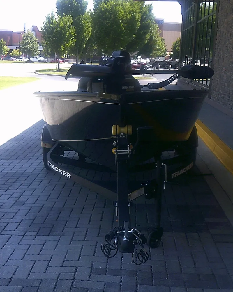Slide: The Image of 2025 Tracker Super Guide V-16 T boat on trailer, parked on brick pavement. - 3