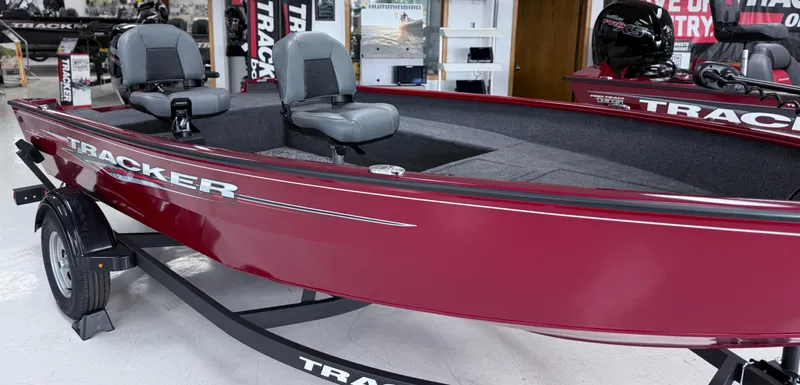The Image of 2025 Tracker Super Guide V-16 T boat, red exterior, displayed in showroom. - 0