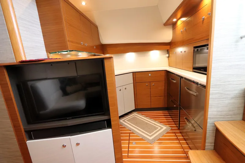 Slide: The Image of Interior of 2020 Tiara Yachts 43 Open, featuring modern kitchen and entertainment area. - 11