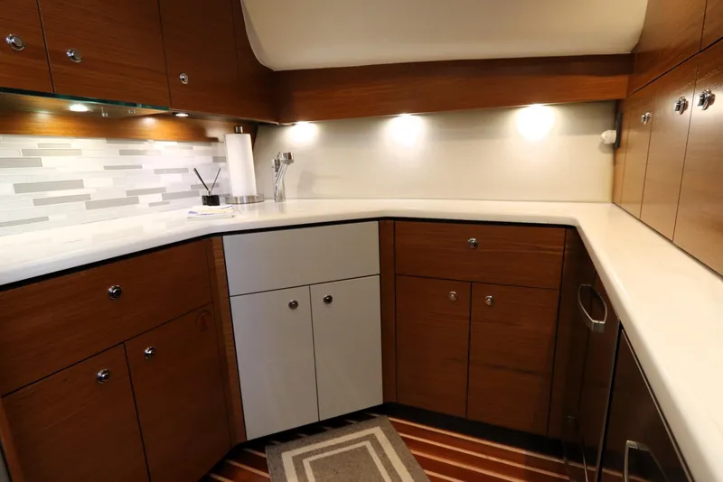 Slide: The Image of Luxurious kitchen interior of 2020 Tiara Yachts 43 Open with modern cabinetry and lighting. - 12