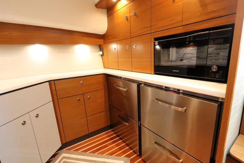 Slide: The Image of Modern kitchen in 2020 Tiara Yachts 43 Open, featuring wood cabinets and stainless steel appliances. - 13