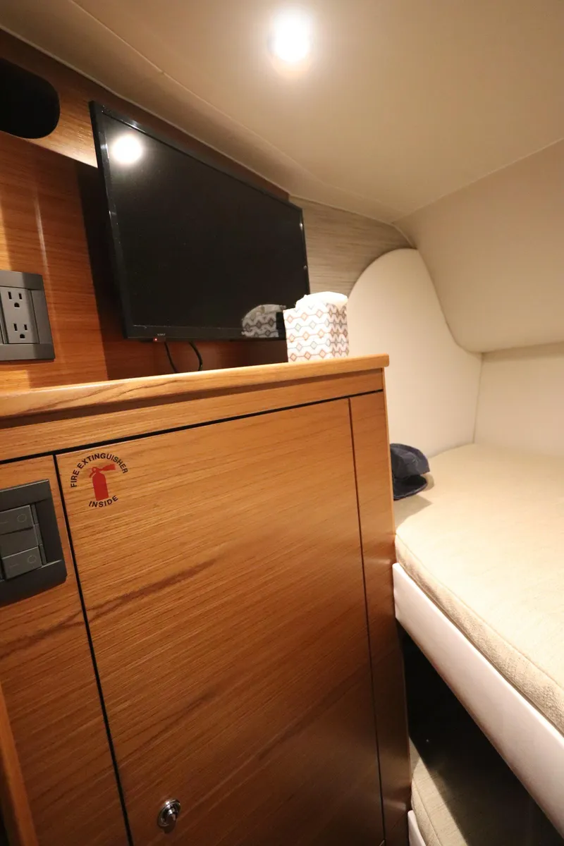 Slide: The Image of Interior cabin of 2020 Tiara Yachts 43 Open with TV and wooden cabinetry. - 15