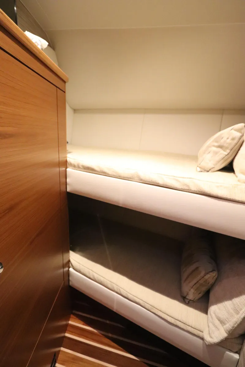 Slide: The Image of 2020 Tiara Yachts 43 Open cabin with cozy bunk beds and wooden cabinetry. - 16