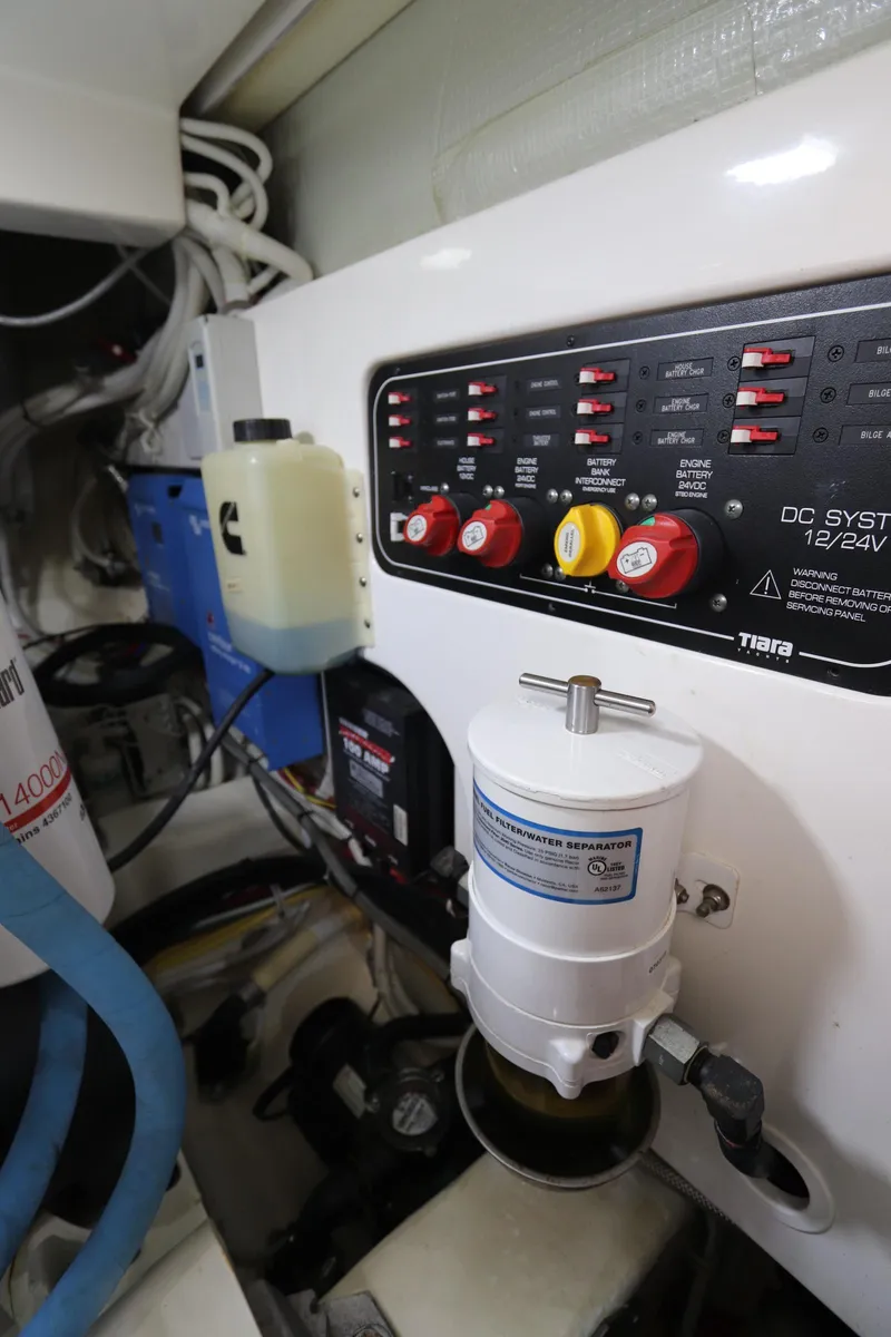 Slide: The Image of Engine room of 2020 Tiara Yachts 43 Open, featuring control panel and fuel-water separator. - 25