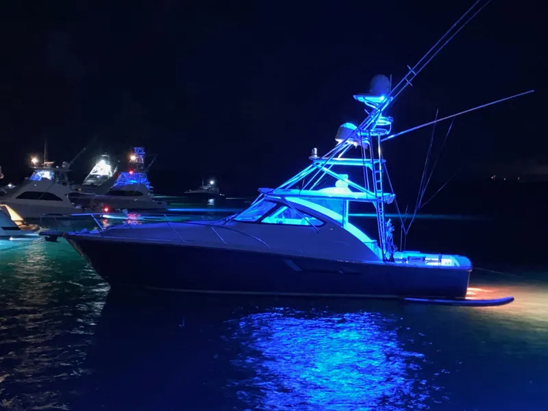 Slide: The Image of 2020 Tiara Yachts 43 Open illuminated at night on the water. - 30