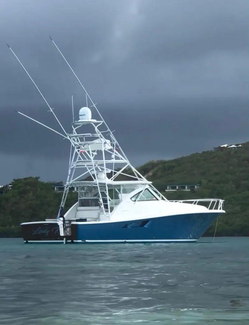 Slide: The Image of 2020 Tiara Yachts 43 Open in serene waters, under a cloudy sky. - 33