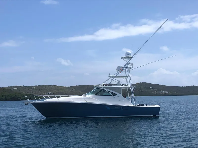 Slide: The Image of 2020 Tiara Yachts 43 Open in calm waters, side view with clear sky. - 34