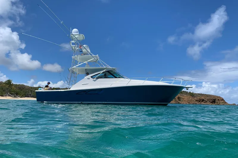 Slide: The Image of 2020 Tiara Yachts 43 Open cruising in clear blue waters under a sunny sky. - 37