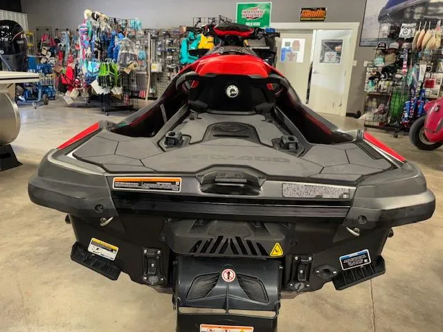 Slide: The Image of 2019 Sea-Doo RXTX jet ski in showroom, rear view, with accessories displayed. - 10