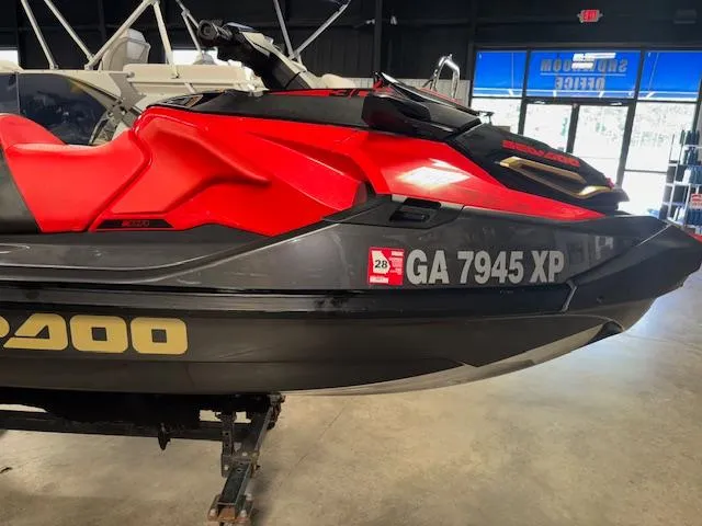 Slide: The Image of 2019 Sea-Doo RXTX jet ski in red and black, displayed indoors. - 14